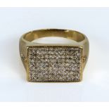 A gents 9ct gold ring set with diamonds, UK size X