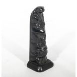 A black pottery totem pole, 20cm tall