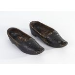 A small pair of treen shoes together with a vintage leather softball