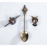 A military silver Gibraltar spoon and two military enamel brooches
