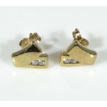 A pair of 9ct gold earrings set with diamonds