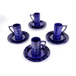 Four retro blue coffee mugs, saucers and side plates