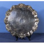 A silver salver with scalloped edge and scrolling feet, Makers mark W&H Sheffield 1892. 12" diameter