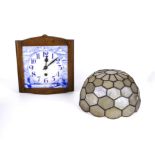 A blue and white pottery wall clock and a light shade