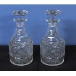 A pair of Georgian crystal glass decanters with mushroom stoppers, 25cm tall