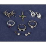 A collection of silver rings, earrings and a cross