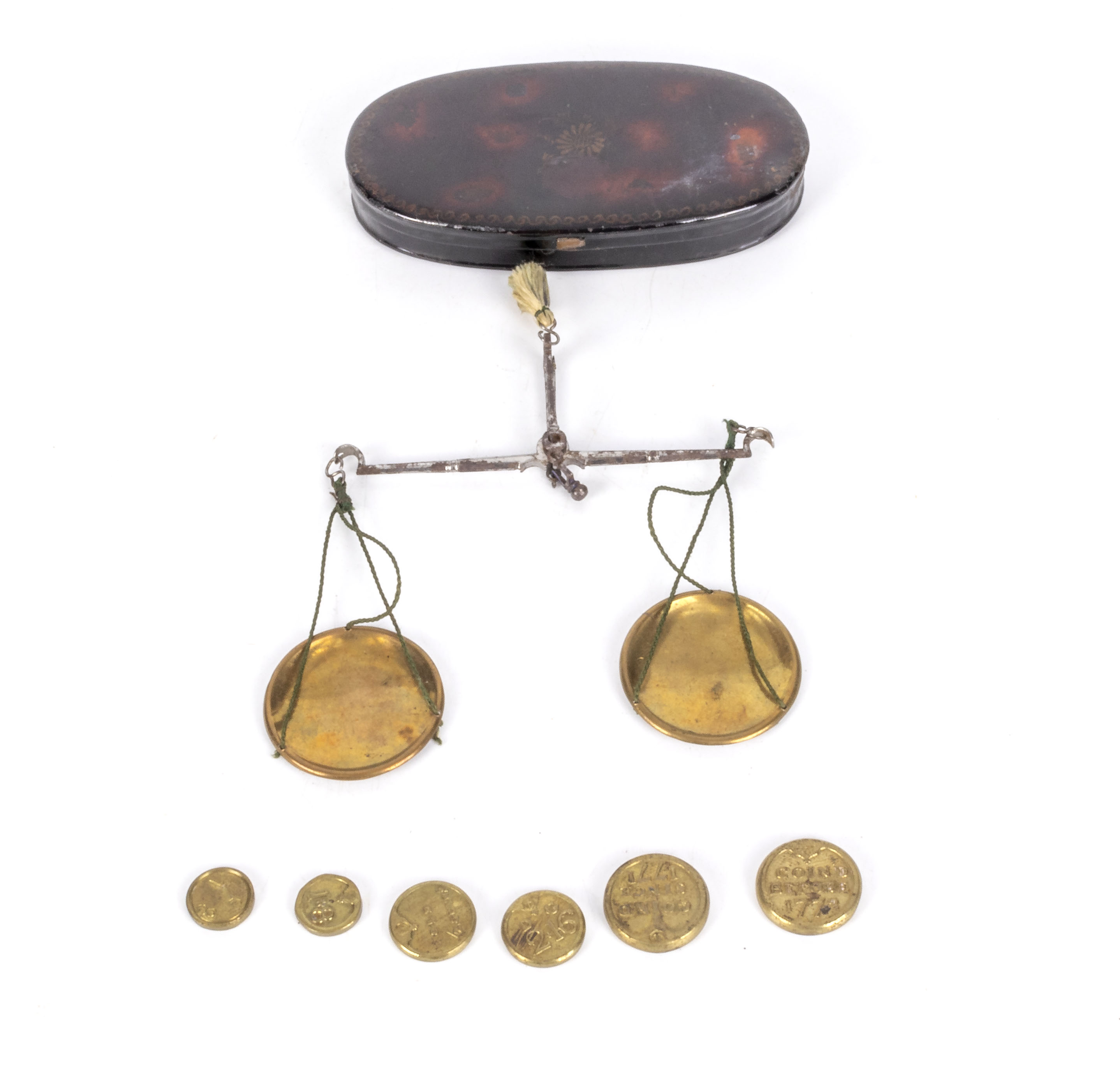 A small pair of weigh scales and weights