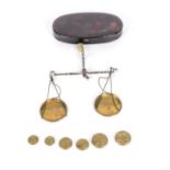A small pair of weigh scales and weights