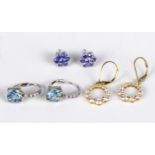 A pair of silver studs set with blue stones, silver hoops and silver gilt earrings