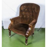 A Victorian mahogany button back arm chair.