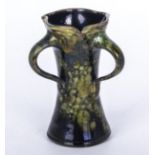 Barnstaple signed William Baron art nouveau vase of unusual form with a green running glaze,