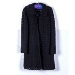 A ladys black crocheted coat, UK size 10/12