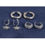 Three pairs of silver earrings, two hoops and dropper stars