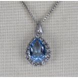A silver chain and pendant set with a blue stone