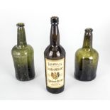 Two 18th century hand blown bottle green wine bottles, with inverted ring moulded tops, height 9"