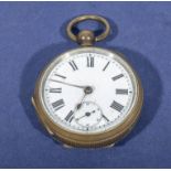 A Victorian brass pocket watch with white enamel dial, in working order