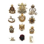 12 assorted Officer’s full dress cap badges.