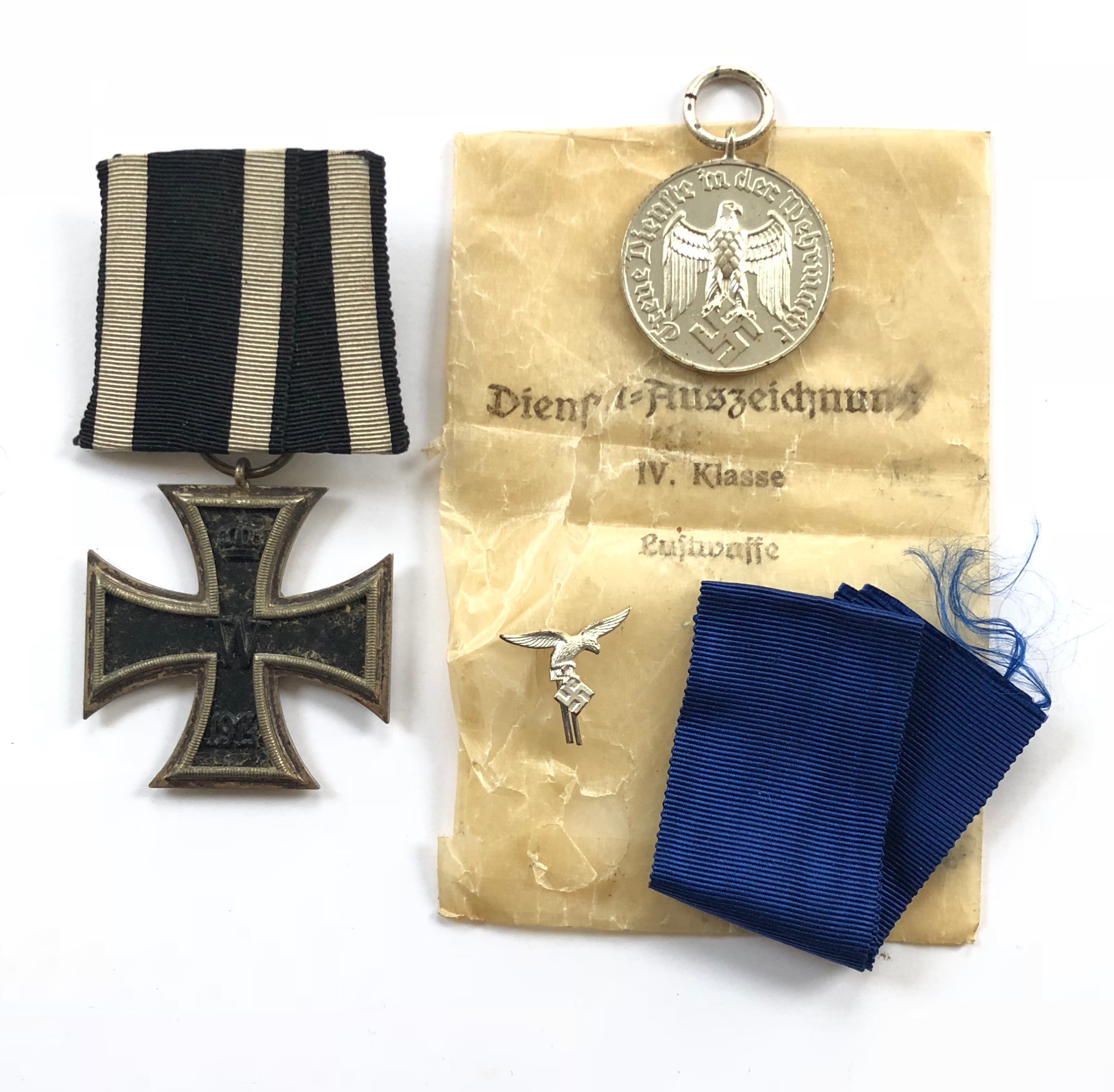 German Third Reich Luftwaffe 4 year Service Medal in packet and an Iron Cross 1914, 2nd Class.