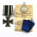 German Third Reich Luftwaffe 4 year Service Medal in packet and an Iron Cross 1914, 2nd Class.