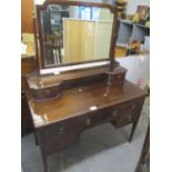 An Edwardian mahogany dressing table having a swing mirror above drawers and tapering legs 60 1/2"
