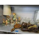 A group of six Hummel figurines and a Hummel style table lamp, a pressed glass dressing table set, a