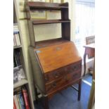 Circa 1900 a ladies bureau, the fall flap enclosing a central cupboard flanked by pigeonholes,