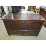 A Georgian oak blanket chest with hinged, folding tops, candle box, panelled front with two base