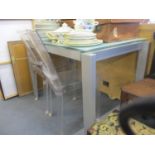 A small contemporary glass and brushed chrome style kitchen table, together with a pair of clear