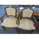 A pair of mid 20th century French walnut armchairs having scrolled arms and cabriole legs