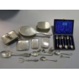 A mixed lot of silver items to include a cased set of six apostle spoons, Georgian spoons, three