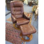 A contemporary brown stressless style chair with matching stool