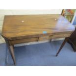 A Regency mahogany fold over card table, standing on tapering legs, 28 1/2"h x 35"w