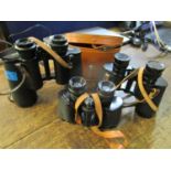 A group of three binoculars to include a Boots empire made 8 x 30 example