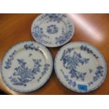 Three English Delft blue and white plates decorated with flora