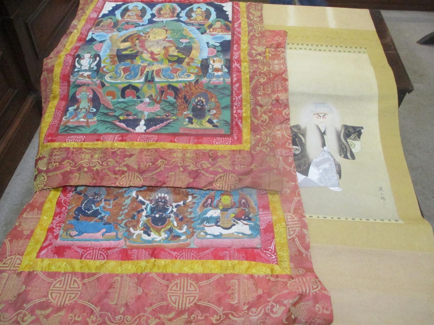 Three Asian panels to include a Japanese scroll and two similar painted and fabric panels