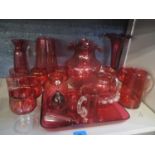 A selection of cranberry glassware to include a posy vase, jug and others