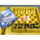 A wooden chess set, complete, with fold over box board, together with a Corgi Aviation archive