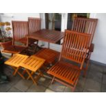 A modern garden teak table, together with four folding chairs and three side tables