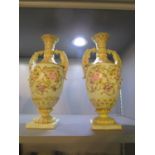 A pair of early 20th century Czechoslovakian porcelain twin handled vases, with floral decoration