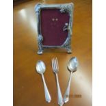 A three-piece silver christening set and a modern Art Nouveau style picture frame