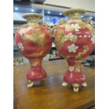 A pair of Satsuma vases with twin handles and floral decoration on a pink ground 14"h A/F