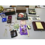 A quantity of costume jewellery, badges, pearl and faux pearl necklaces, vintage leather boxes and