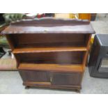 A South African hardwood bookcase cabinet with a shelf and two doors