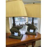A pair of Verdigris metallic table lamps in the form of elephants with pleated shades