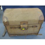 An early 20th century brown canvas and leather arched top trunk with an impressed Royal Warrant