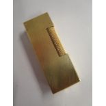 A Dunhill gold coloured lighter. Location:Cab