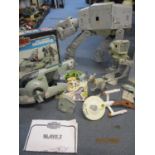 A Kenner Star Wars Rebel Armoured Snow speeder vehicle, a Star Wars AT - AT Walker vehicle, a