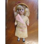 An Edwardian bisque headed doll in original dress