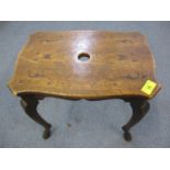 A Welsh mahogany lamp table in the style of Arts and Crafts with carved Welsh Dragon carvings and