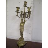 A brass figural candelabrum in the form of a knight